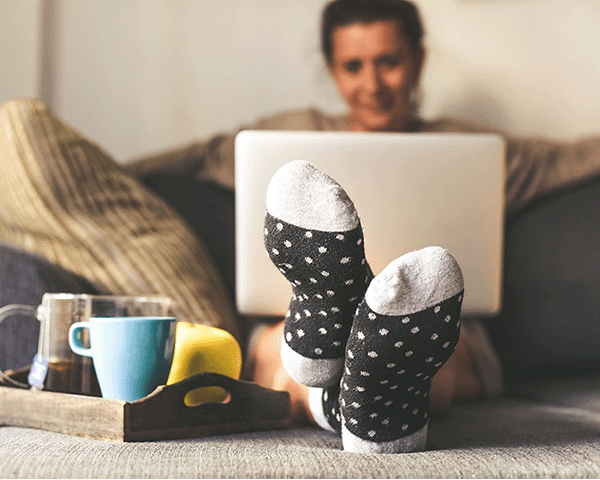 woman with feet up reading from computer