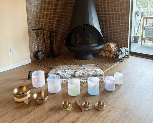 singing bowls in front of fireplace